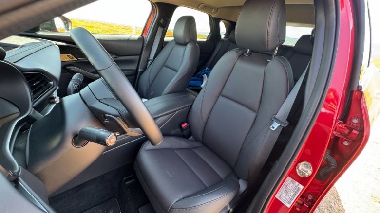 A look through the open driver's door at the black leather driver's seat