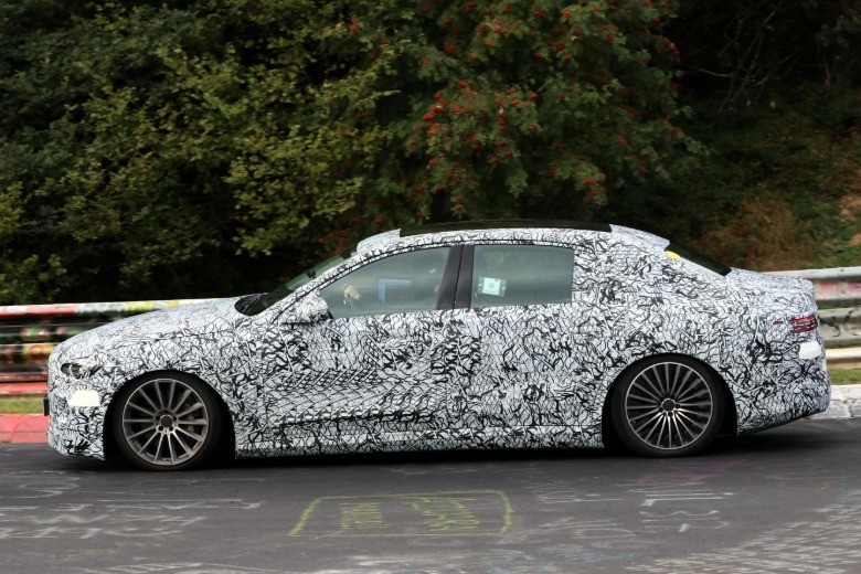 Side view of a camouflaged Mercedes-Benz E-Class EV prototype