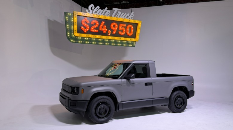 A grey Slate truck with a pricing sign behind it