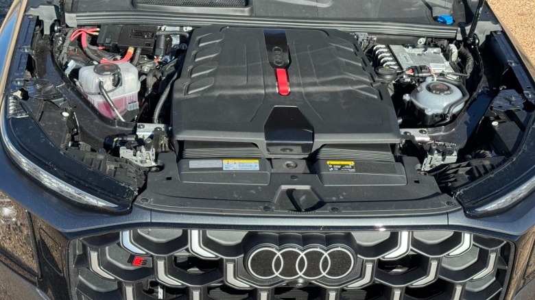An underhood shot of the SQ9 parked on dirt showing the V8