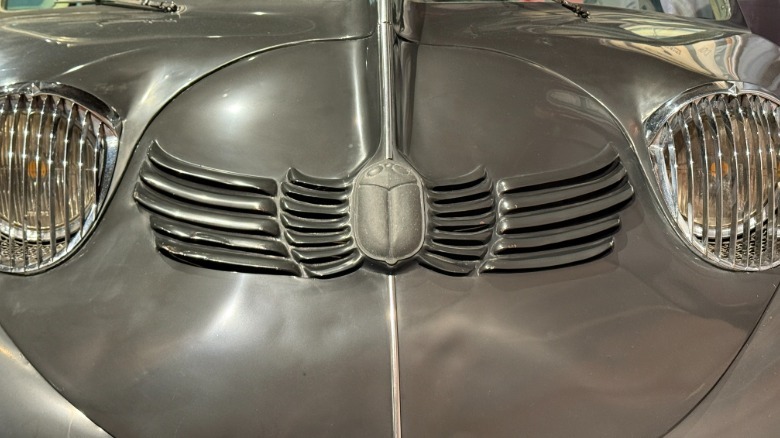 The front hood/face of the Stout Scarab with a scarab beetle prominent in the center