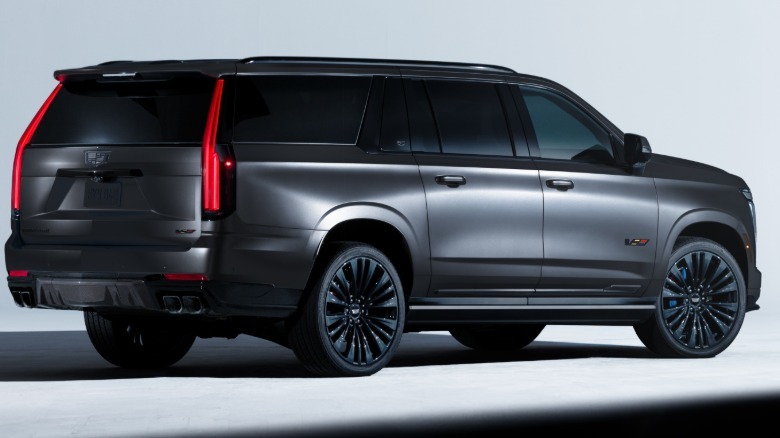 rear three-quarters shot of a black Escalade Collectors Series parked in a white photo studio