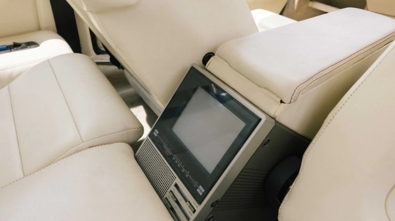 A close-up of the rear seat TV showing no rear legroom but lots of beautiful white leather