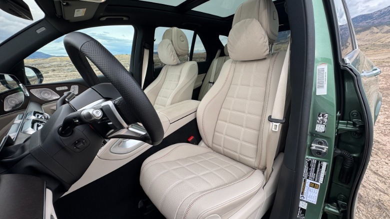 A photo looking back into the driver's door at the tan front seats in the 500e