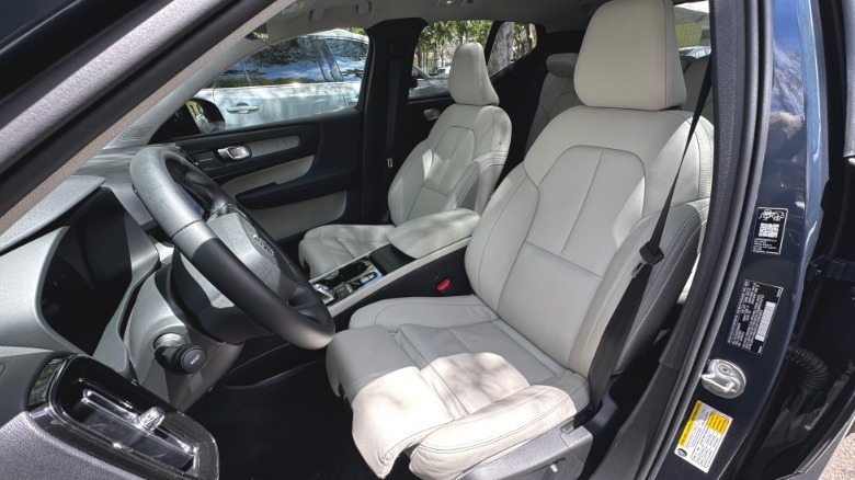 A look into the driver's side door showing the white leather seats