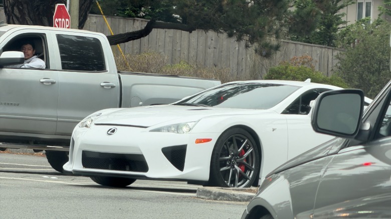 A white Lexus LFA peeking through traffic