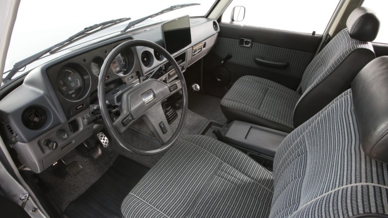 A look at the dashboard and front seats inside the Turbo Trail Cruiser showing mostly original parts