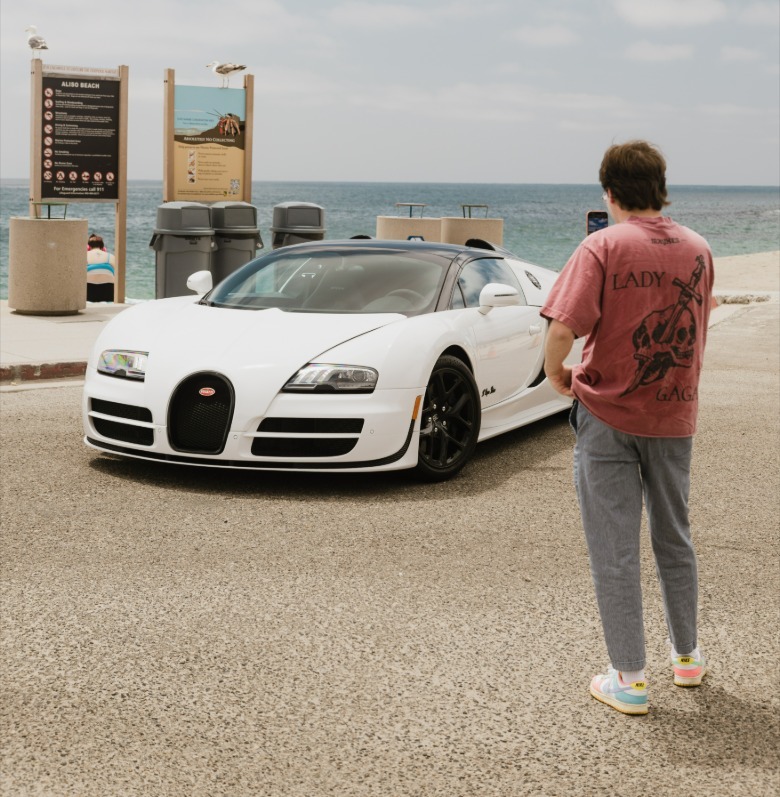 The author taking a photo of a white Bugatti Veyron Grand Sport Vitesse