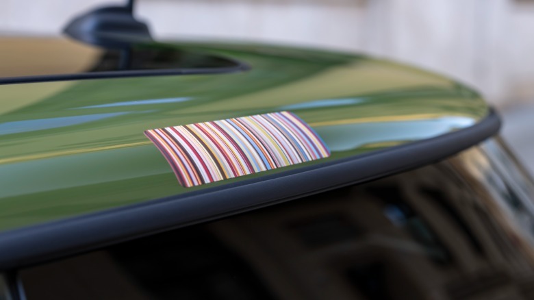 A close-up of Paul Smith's Signature Stripes on the green roof of a Mini Cooper Hardtop