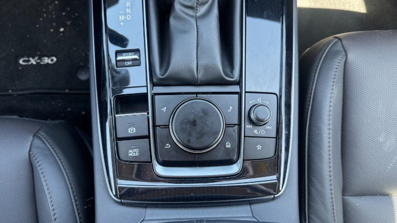 A photo of the center console in the CX-30 showing the scroll wheel and other buttons