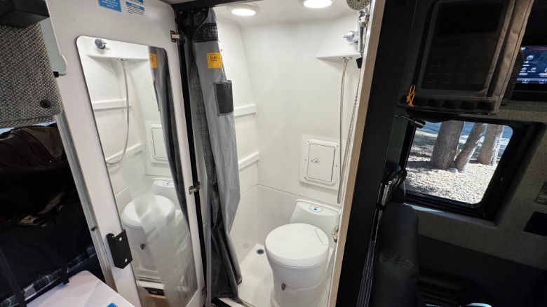 A look inside the BeastMode XO's wet bathroom with a cassette toilet and a shower with a mirror on the door