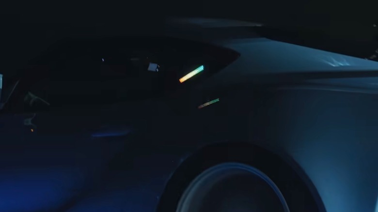 Close-up side view of an audio level display in the rear side window of a Toyota GR Supra