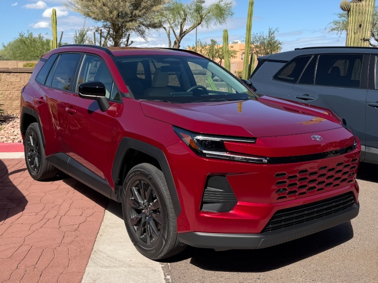Front 3/4 view of a red 2026 Toyota RAV4 XLE Premium