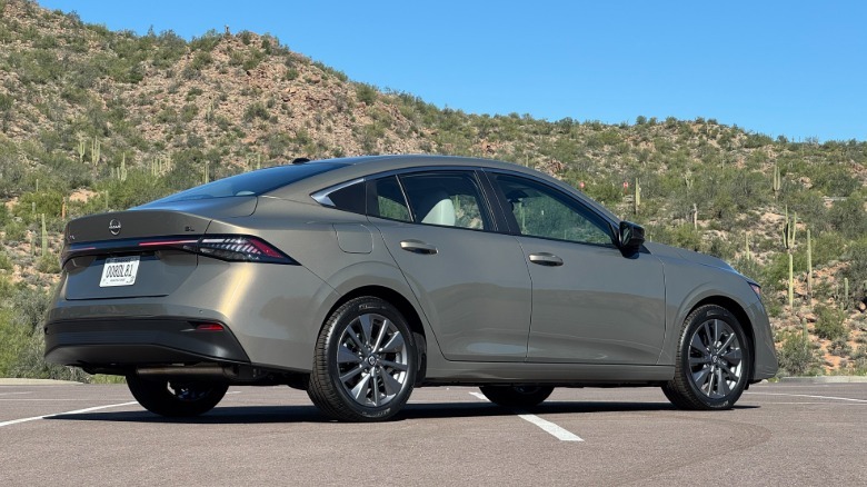 A rear three-quarters changeable of nan tan Sentra SL parked successful a batch successful beforehand of godforsaken mountains pinch cactus and shrubs