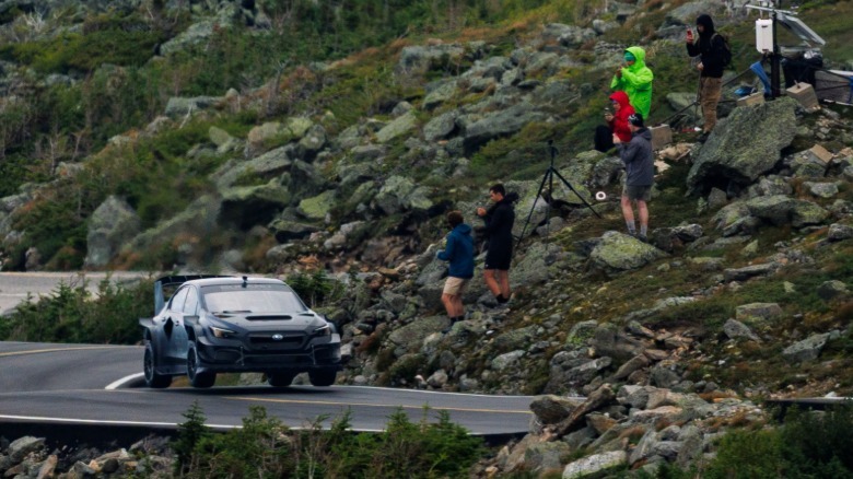 Scott Speed and Project Midnight catch air over bumps on the Mount Washington Auto Road as spectators watch