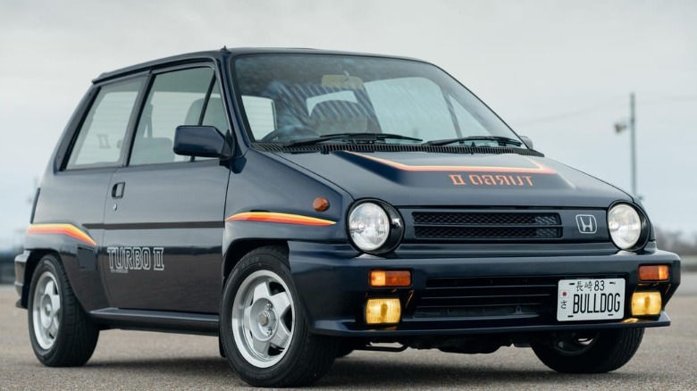 front three-quarters shot of the perfect dark blue Honda City Turbo II with its fog lights on