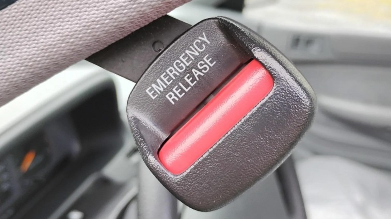 Automatic seat belt emergency release