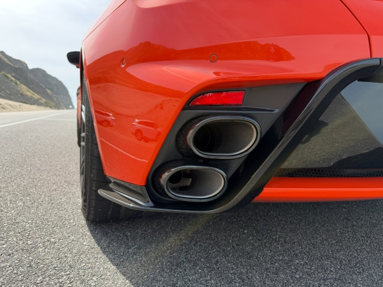 Exhaust tips of an orange Aston Martin DB12 S