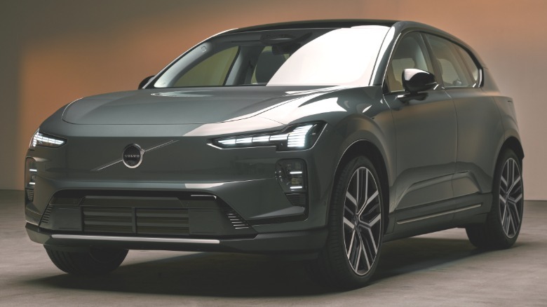 front three quarters shot of the teal EX60 parked in a photo studio with its DRLs on