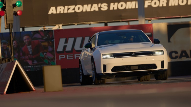 front shot of a white Charger EV lined up at the start line of a drag strip in Arizona