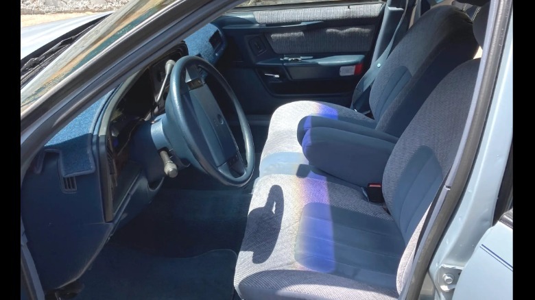 A look through the open driver's door showing the all blue interior of the Sable