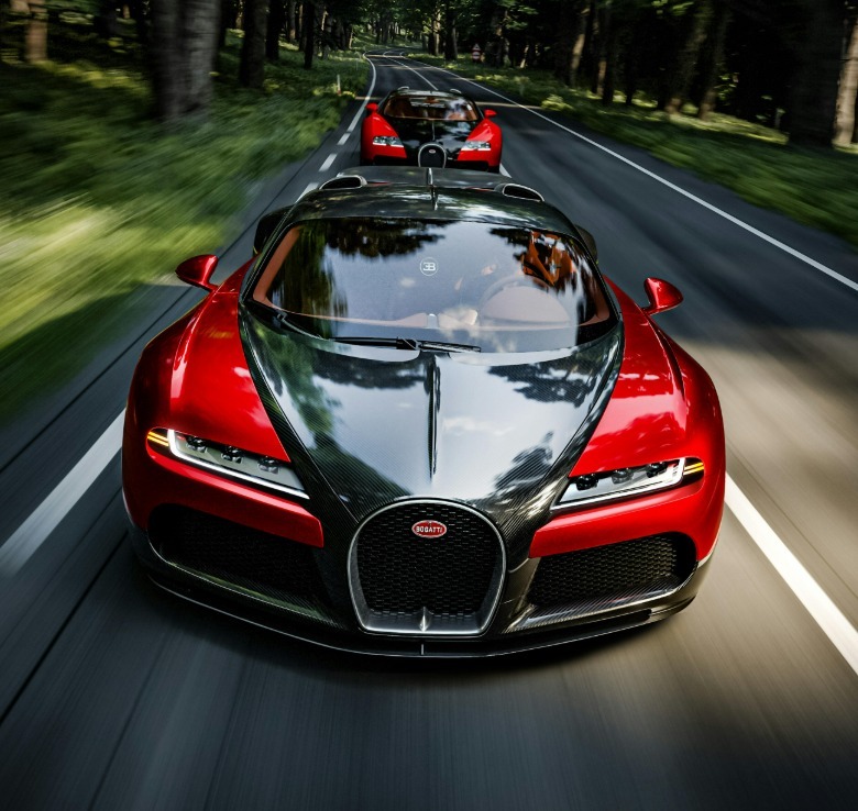 The black and red Bugatti F.K.P. Hommage driving in front of a black and red Bugatti Veyron