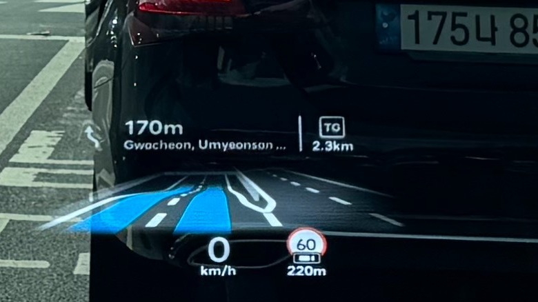 A photo of the HUD projected onto the windshield showing simulated lanes