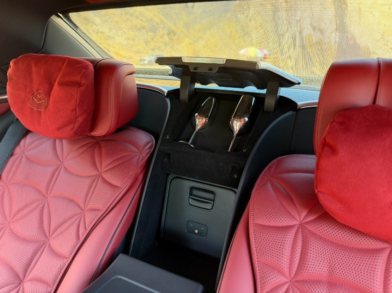 Champagne flutes in a 2027 Mercedes-Maybach S680