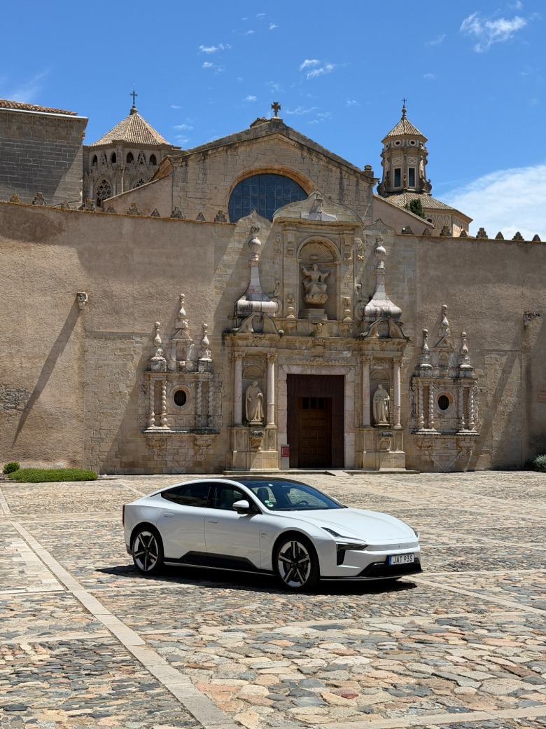 A white Polestar 5 in front of a monastery