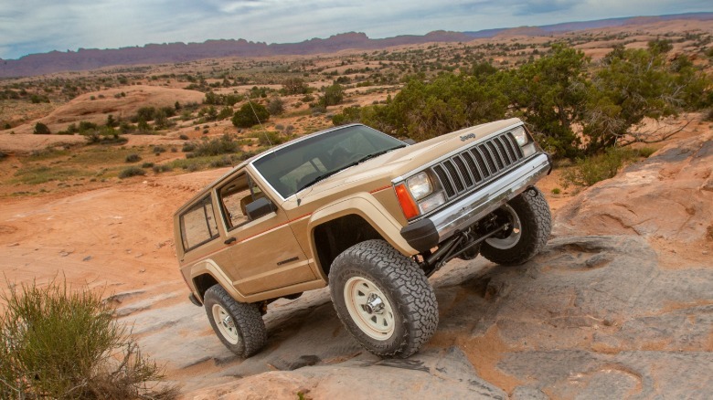 Front 3/4 view of the XJ Pioneer climbing a hill at Moab
