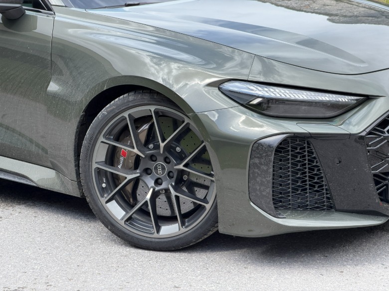 Front wheel of a green 2027 Audi RS5