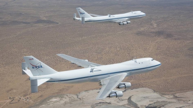 NASA's Shuttle Carrier Aircraft 905 (front) and 911 (rear) were captured by photographer Carla Thomas as they flew in formation over the Rio Tinto Borax mine west of Boron