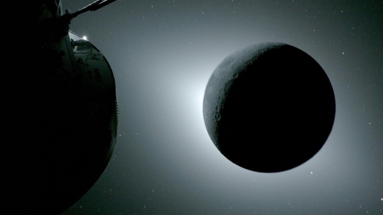 The Artemis II capsule viewing a total solar eclipse behind the moon