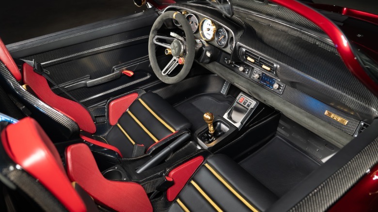A shot of the interior looking down from above the passenger seat showing the various carbon fiber bits and a red